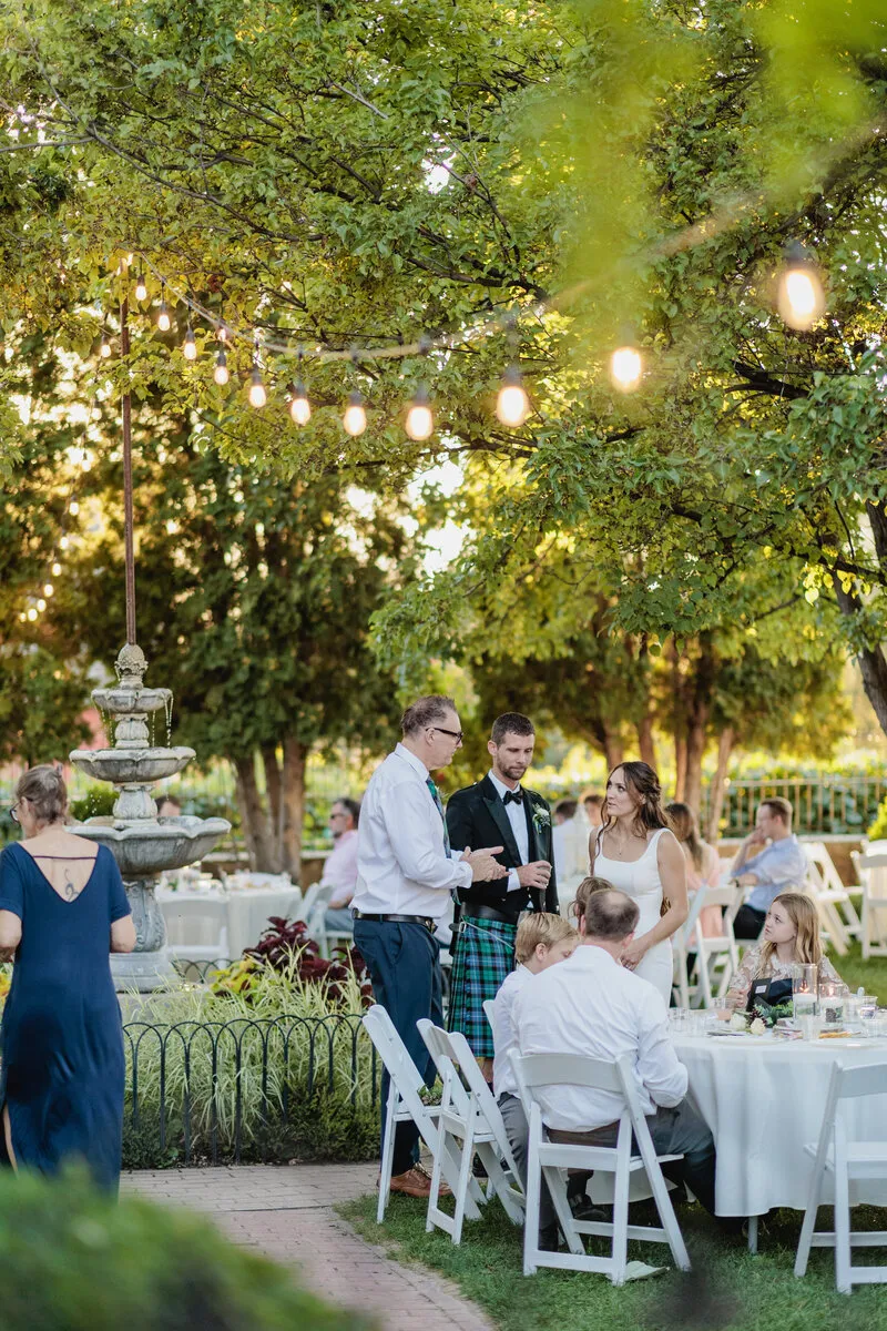 Bride and Groom mingle with guests during a wedding dinner
