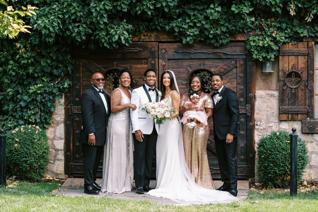 Wedding pictures in front of the ivy covered stone
