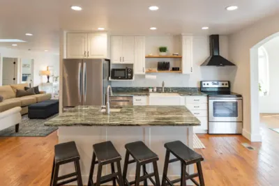 The kitchen shows white cabinets