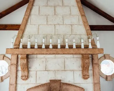 Small white vases line the fireplace mantle at Wadley Farms